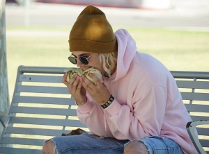 Someone posing as Justin Bieber eating a burrito sideways to incite discussion on social media